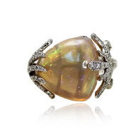 White Gold Ring With A Soft Trilliant Cut Opal And Brilliant Cut Diamonds